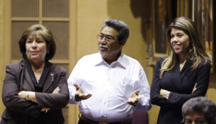 Sen. Amanda Aguirre, D-District-24, left, looks on as Sen. Manny Alvarez, D-District 25, gestures while talking with her and Sen. Rebecca Rios, D-District 23, on the Senate floor during a special session in the Arizona Senate at the state capitol on Nov. 19, 2009, in Phoenix. (AP Photo / Ross D. Franklin)